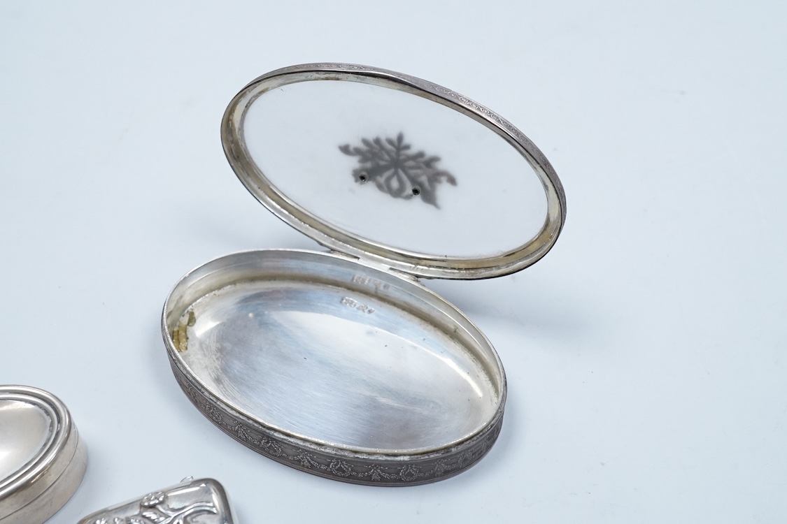 A continental 935 standard white metal oval box, with inset frosted glass and marcasite set hinged cover, 82mm, together with three assorted small pill boxes, including enamelled(a.f.), an Italian 800 standard and a mode